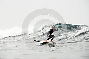 Girl surfing the wave in the ocean