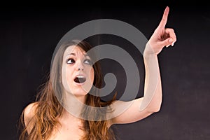 Girl surprised and pointing upwards.