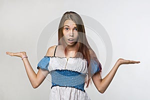 Girl is surprised, and throws up his hands. Portrait on white background