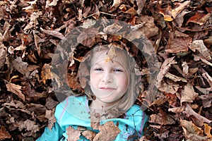 Girl surrounded by leaves