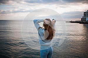 Girl in a sweater near the sea