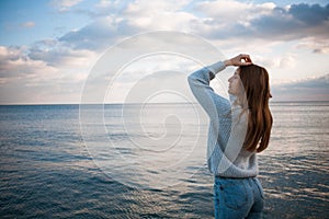 Girl in a sweater near the sea