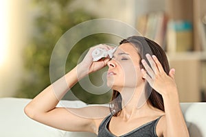 Girl sweating and fanning at home in a warm day photo