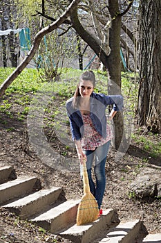 Girl sweeps with a sweeper