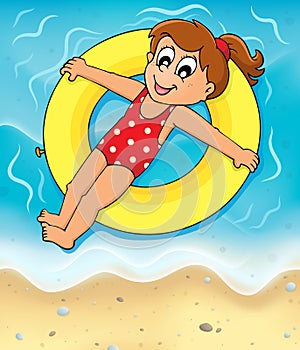 Girl on swim ring at seashore