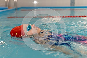 Girl swimming backstroke. open water competition among children. Sports and entertainment for children. Swimming competition.