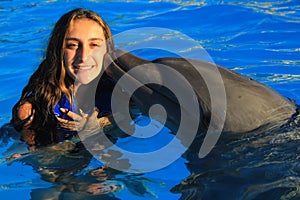 Beautiful girl kissing a gorgeous dolphin flipper smiling face happy kid swim bottle nose dolphins photo