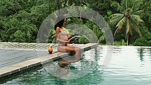 girl swimming in infinity pool with in private villa resort. book Ubud, Bali.