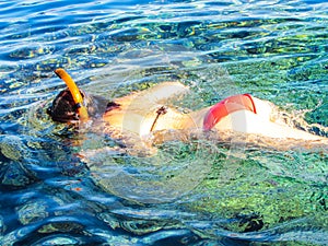 Girl swimming in mask in sea