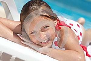 Girl by the swimming pool