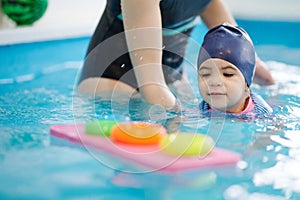 Girl in swimming suit learn how to swim