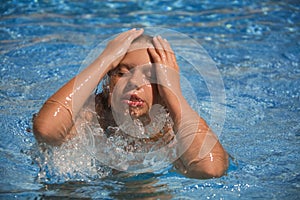 Girl swimming in the swimming pool