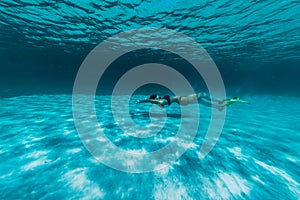 A girl swims underwater