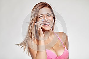 Girl in swimsuit gets on the nose cream and smiles