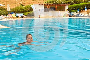 Girl in swimsuit swimming in pool, Bali, Crete