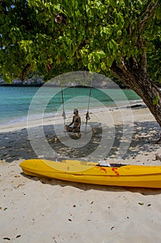 Girl on the swing in a beach