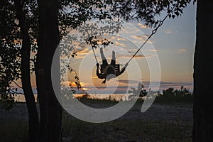 Girl on swing by sea in autumn sunset, family walk in nature, fall vibes, travel, active lifestyle