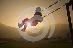 Girl on Swing at sunset