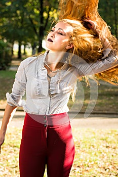 Girl swinging hair in the park