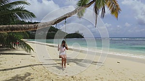 A Girl Swinging On A Palm Tree, Baie Lazare Beach, Seychelles