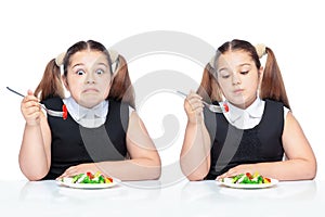 Girl at the table eating salad, overweight child. proper nutrition for schoolchildren .