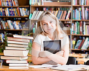 Girl with tablet computer in library