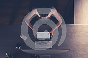 Girl with a Tablet and Headphones Studying at her Desk