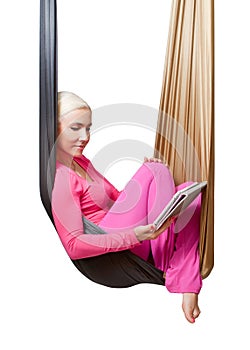 The girl with the tablet resting in the hanging hammock