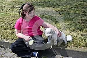 Girl takes a break and cuddles with her dog photo