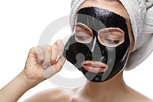 Girl takes off black cosmetic mask from her face