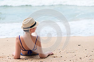 Girl takes a sun bath on a sandy beach