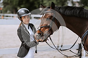 Girl taking care of her horse before horse riding. Equestrian sport