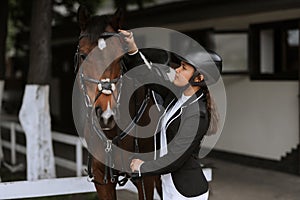 Girl taking care of her horse before horse riding. Equestrian sport