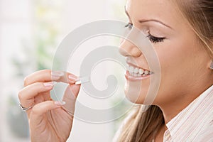 Girl taking chewing gum photo