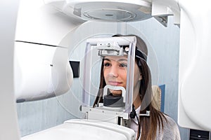 Girl taking digital 3D panoramic dental x-ray.