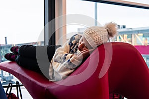 Girl taking a nap while waiting at the airport