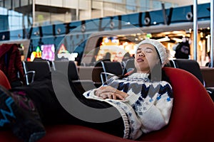 Girl taking a nap while waiting at the airport