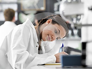 Girl Taking Notes In Science Class