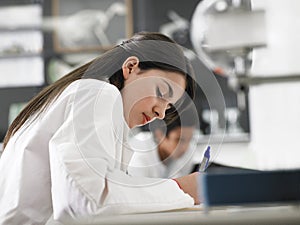 Girl Taking Notes In Science Class