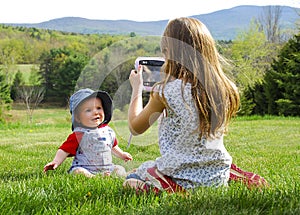 Girl Taking Photo of Baby