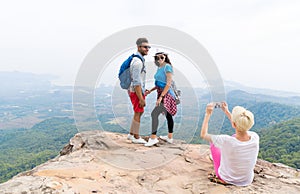 Girl Taking Photo Of Couple With Backpacks Posing Over Mountain Landscape On Cell Smart Phone, Trekking Young Man And