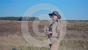 girl taking photo in a field