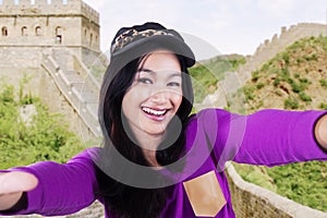 Girl taking photo at Great Wall of China