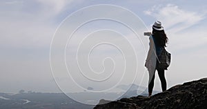 Girl Taking Photo Of Landscape From Mountain Top On Cell Smart Phone, Female Tourist With Backpack Standing On Cliff