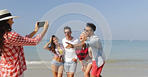 Girl Taking Photo Of People Group On Beach On Cell Smart Phone Happy Cheerful Man And Woman Posing Tourists On Vacation