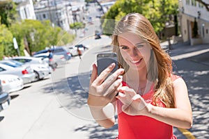 Girl taking photo with smartphone.