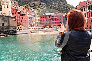 Girl is taking a photo of Vernazza village