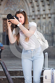 Girl is taking photos on her camera