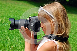 Girl taking photos by professional reflex camera