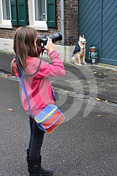 Girl is taking photos with a SLR camera